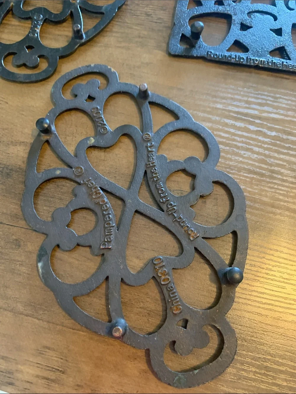 The Pampered Chef Copper-Tone Ornate Trivet Set.